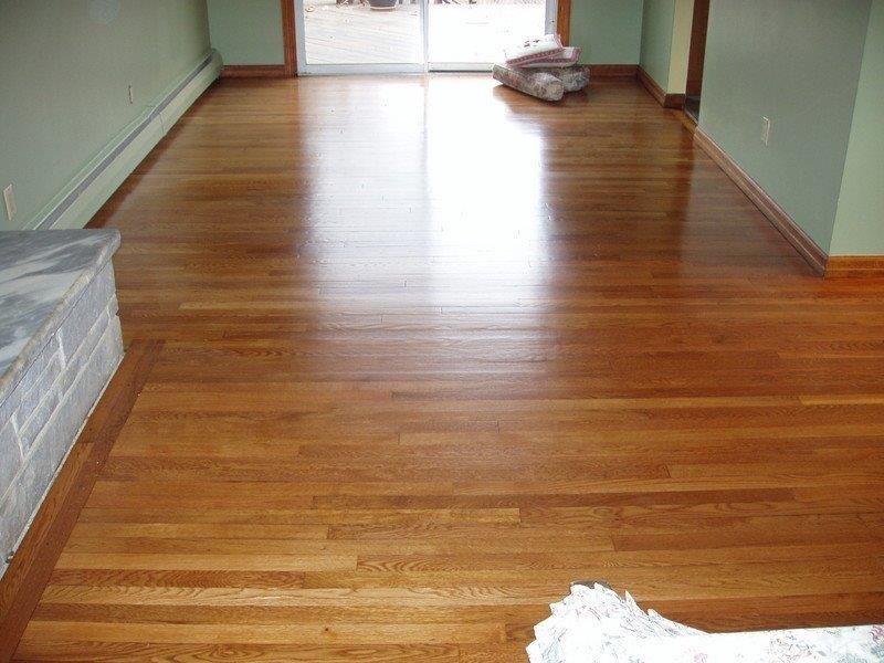 A living room with hardwood floors and a sliding glass door.
