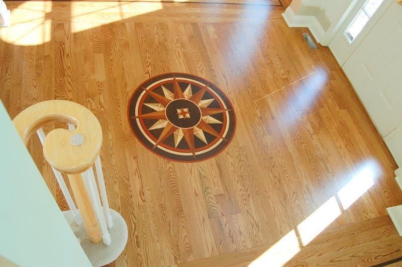 A wooden floor with a circular design on it