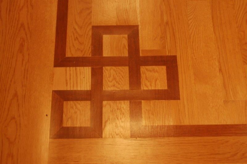 A wooden floor with a geometric design on it
