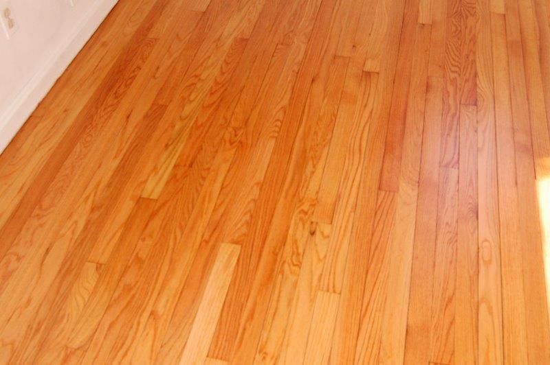 A close up of a wooden floor in a room.