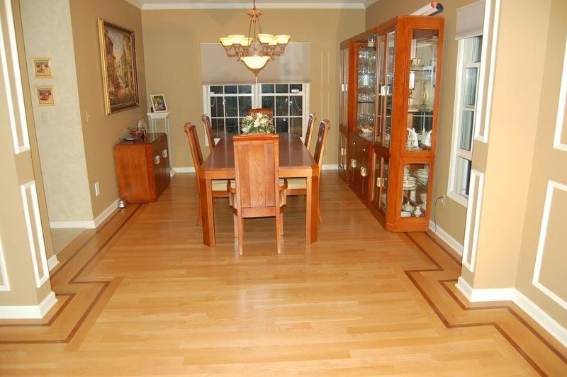 A dining room with a wooden table and chairs