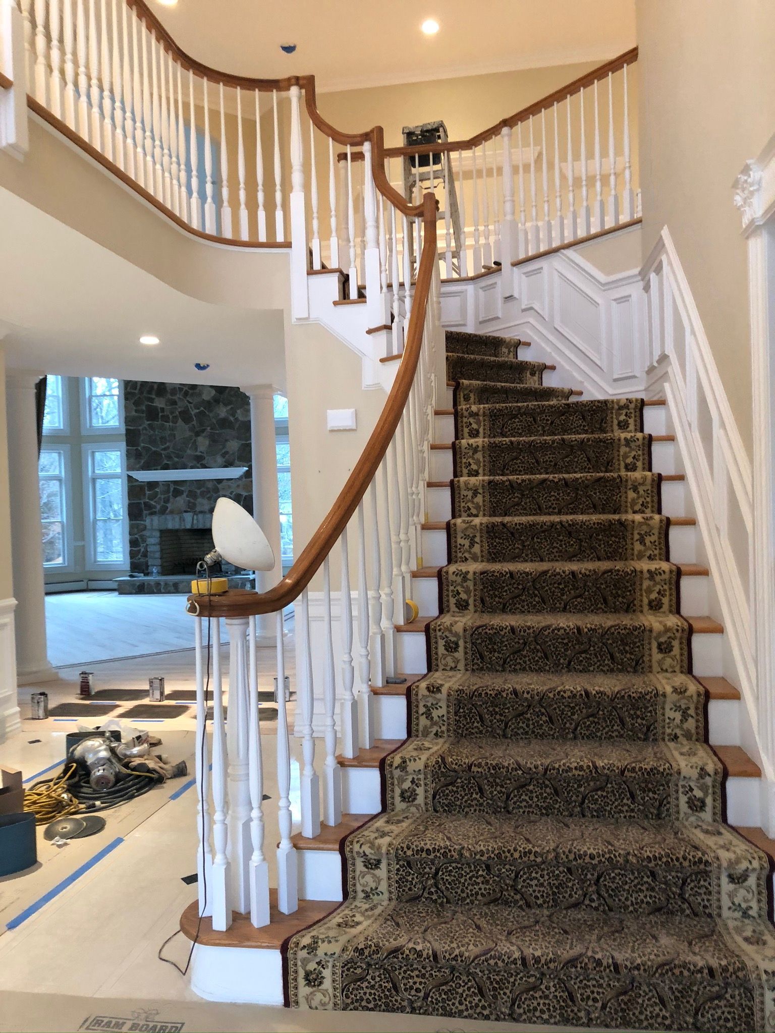 A staircase with a carpeted staircase and a wooden railing in a house.
