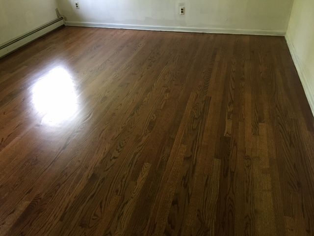 A room with a wooden floor and white walls.