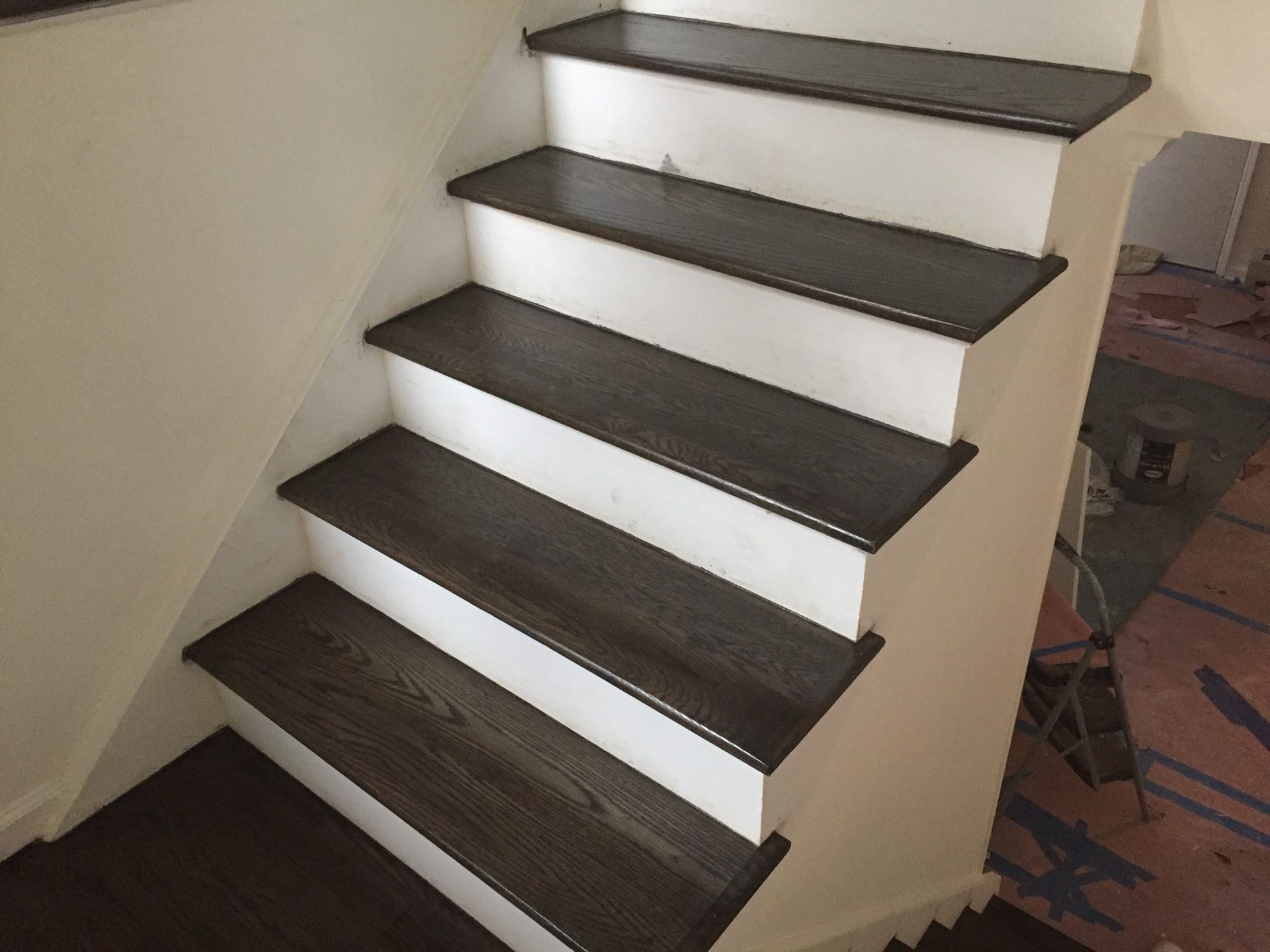 A set of stairs with dark wooden steps and white risers