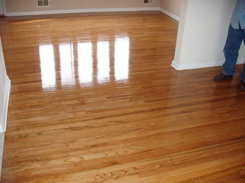 A person standing on a wooden floor in a room