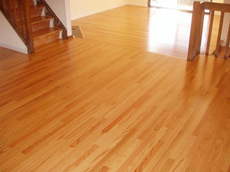 A living room with hardwood floors and stairs.