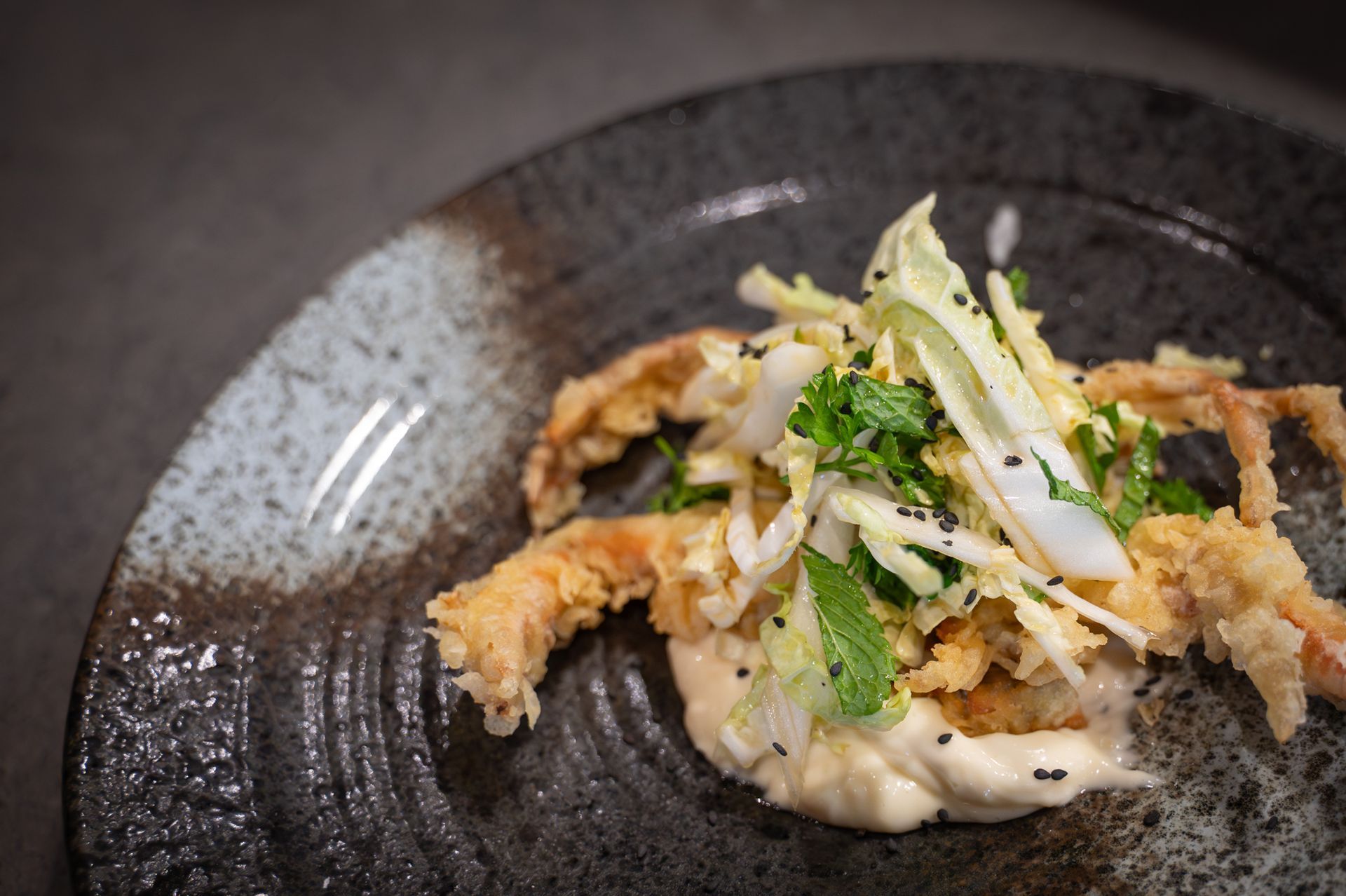 Grilled chicken and vegetable skewers on a white plate on a dark wooden table