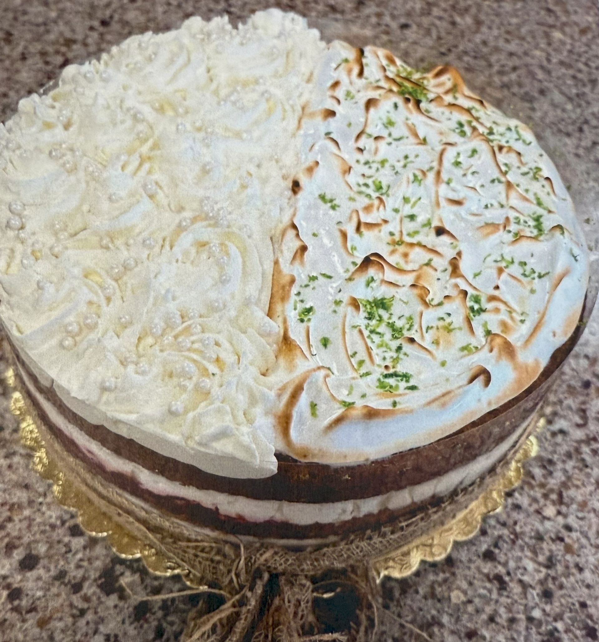 Cake, half whipped cream, half toasted meringue, with lime zest. Chocolate and white layers.