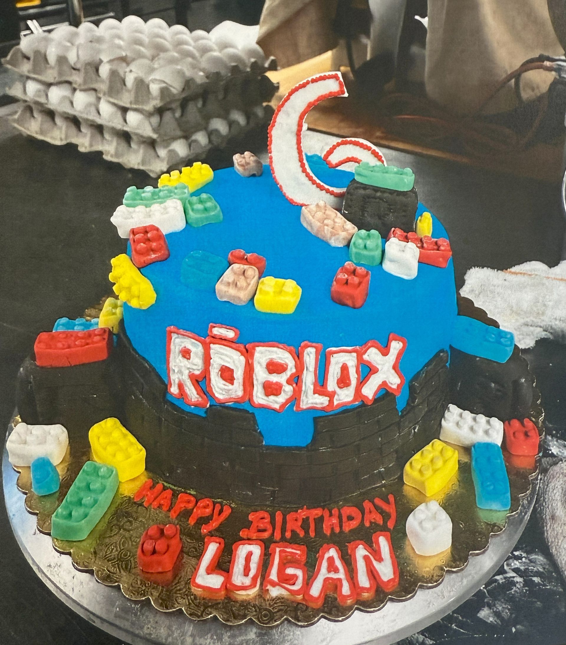 Birthday cake with Roblox theme, blue frosting, colorful blocks, 