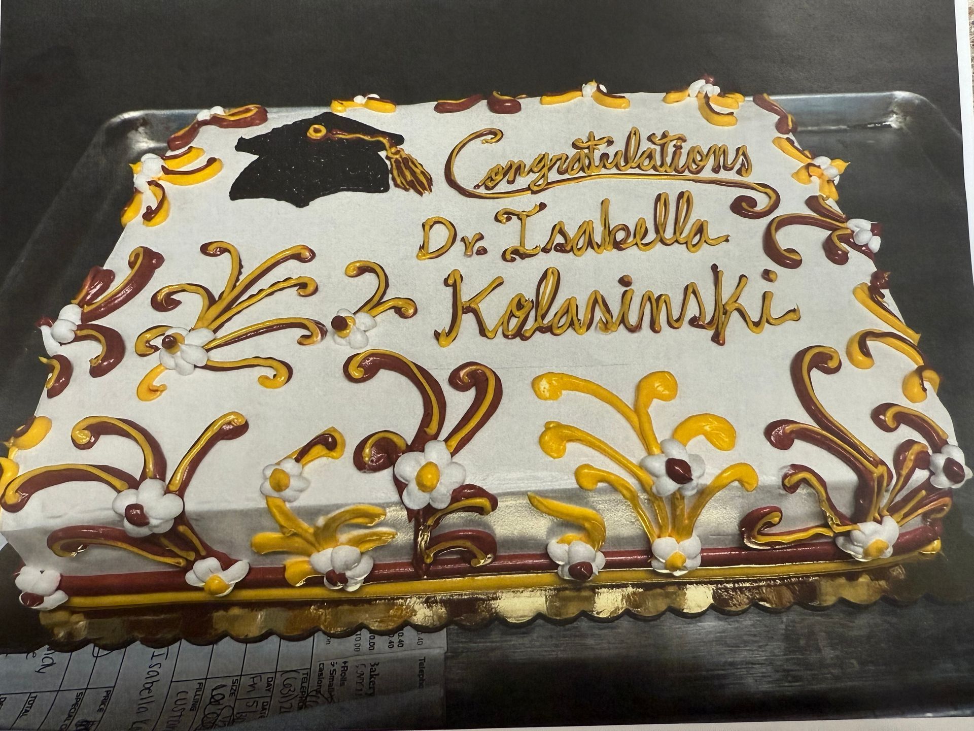 Graduation cake: White with gold and burgundy swirls, 