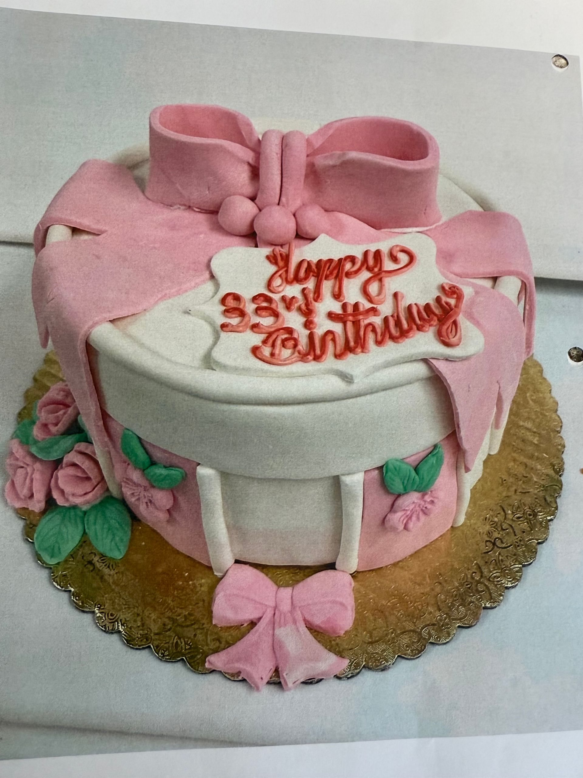 Pink and white gift box cake with bow, roses, and 