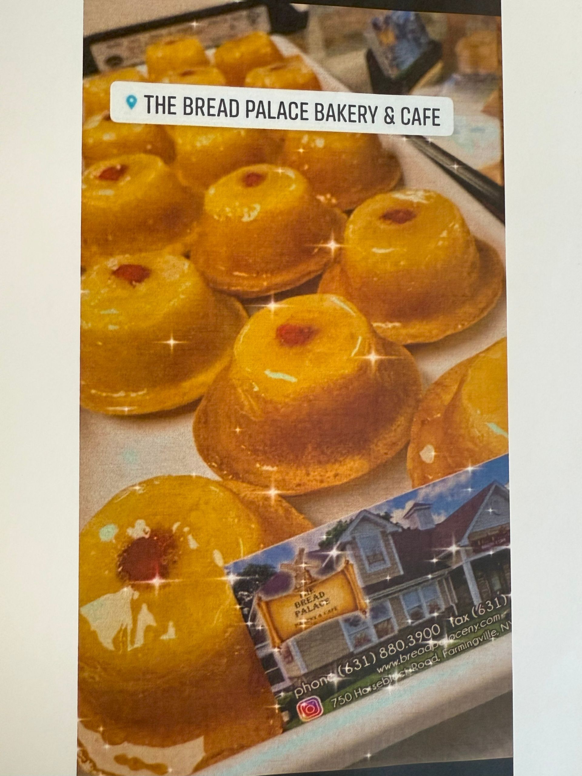 Pineapple upside-down cakes at The Bread Palace Bakery & Cafe. Yellow cakes with cherry topping on a white tray.