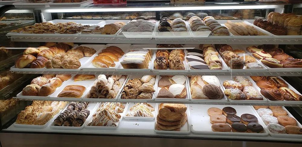 Display case filled with various pastries at a bakery.