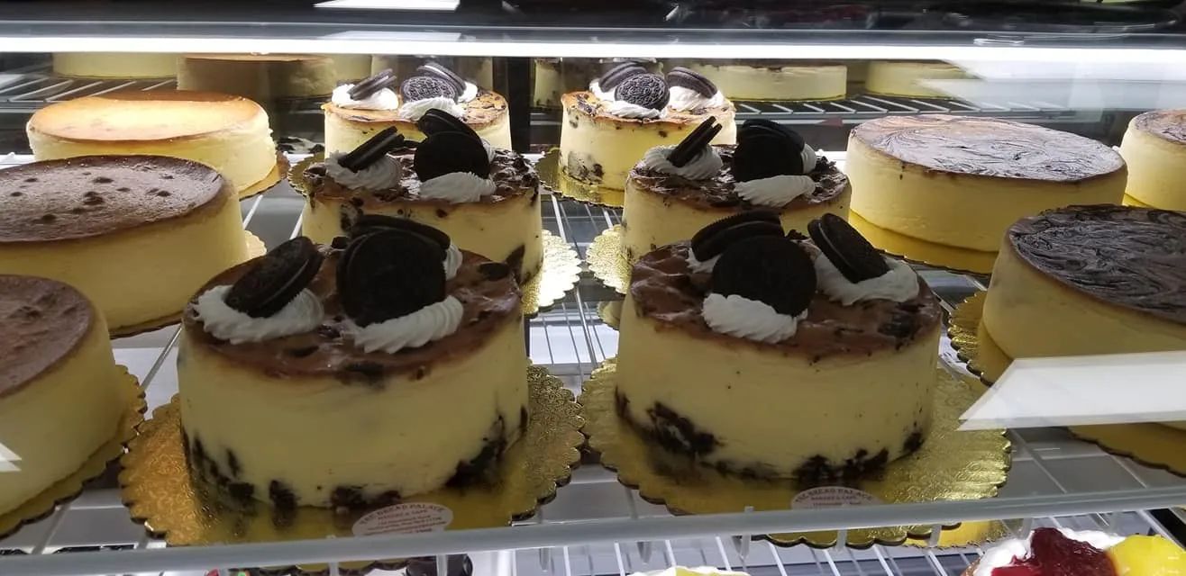 Cheesecakes in a display case; some with Oreos and others plain.