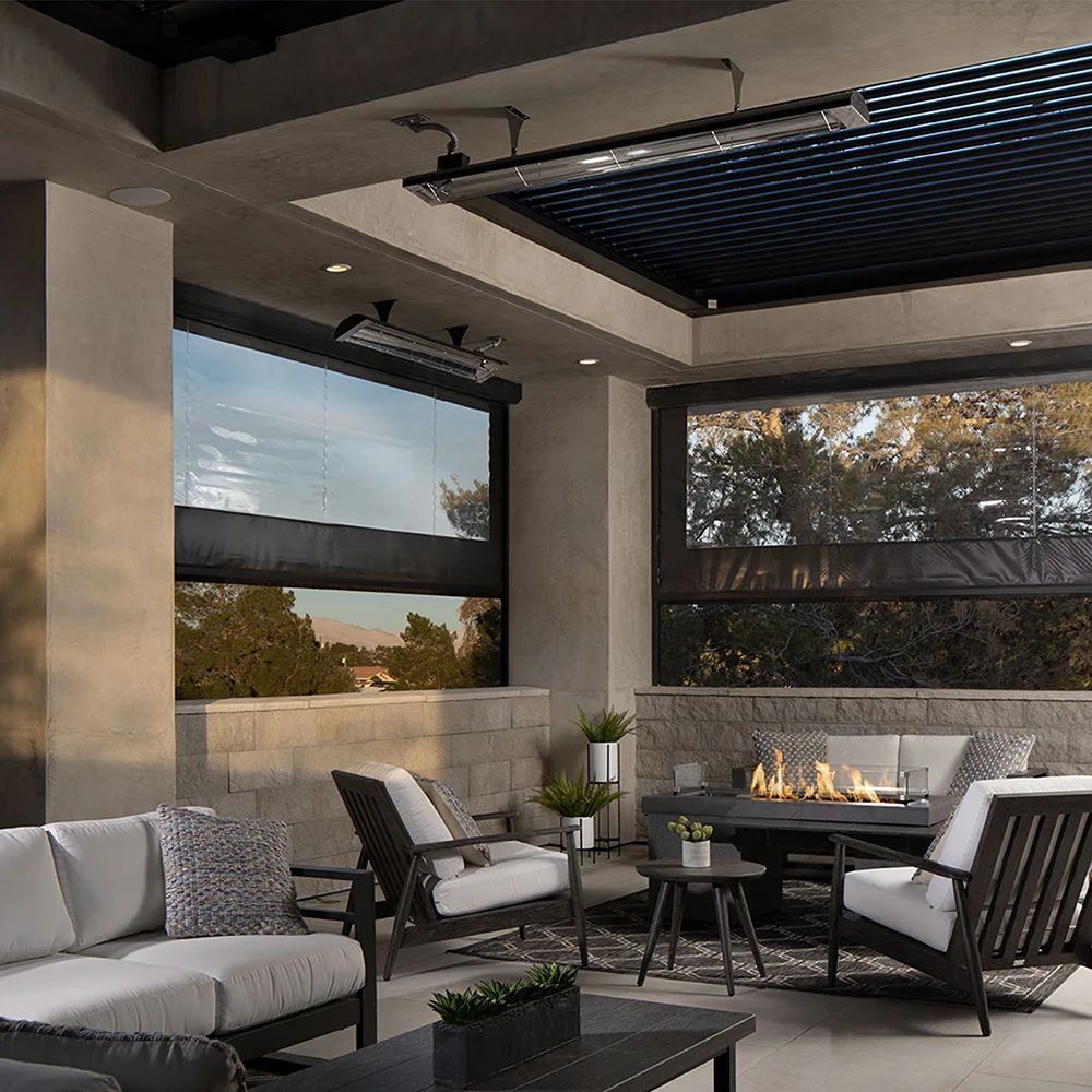 Outdoor patio with seating, fireplace, and retractable shades.