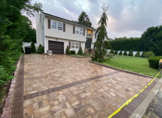 A house with a newly paved brick driveway.