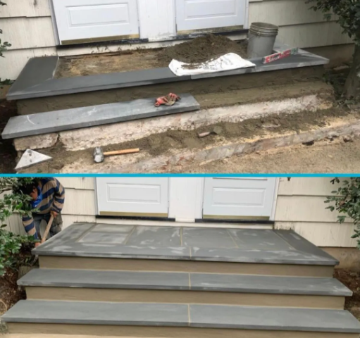 Construction of new stone steps at a doorway. A worker lays stone over cement. The finished steps are gray.