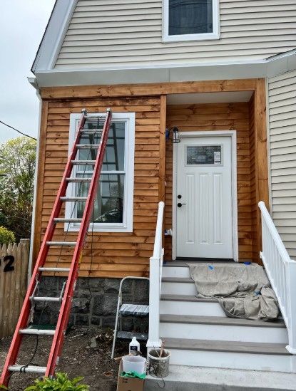 after photo of a house exterior with new wood siding