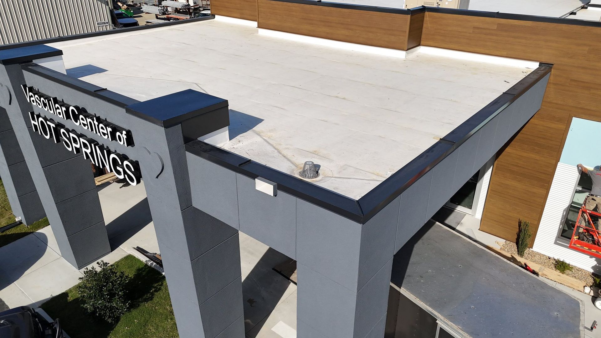 Exterior view of the Hot Springs Convention Center roof, grey and brown building, with a flat roof.