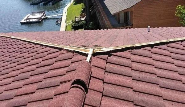 Red tiled roof with a valley gutter, overlooking a lake and dock.