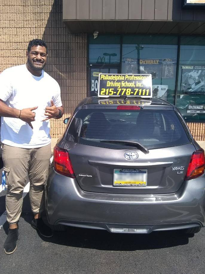 Tall man wearing a white shirt successfully passed driving school test