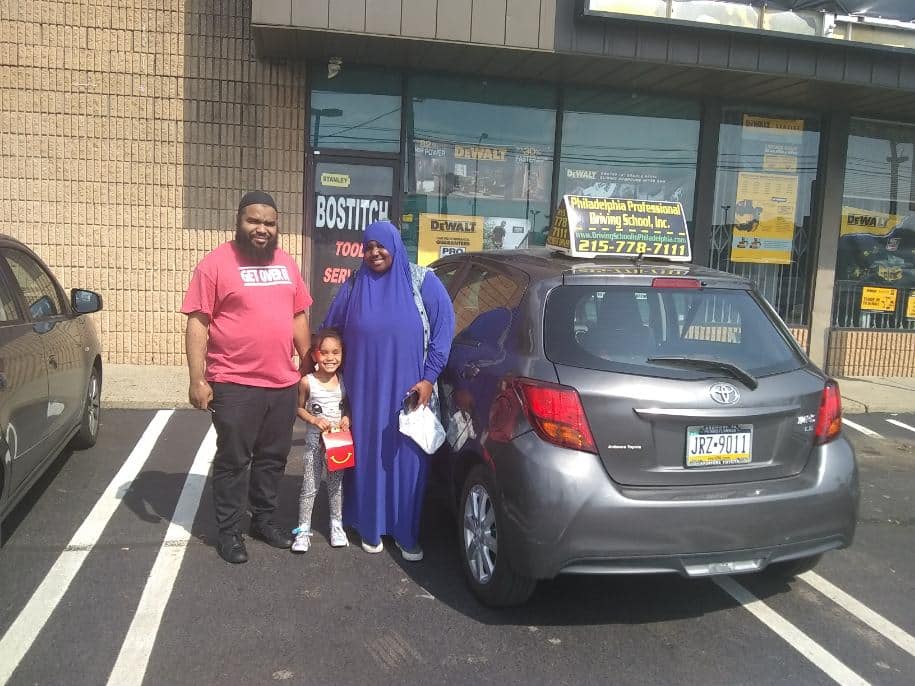Parents with daughter on the parking lot