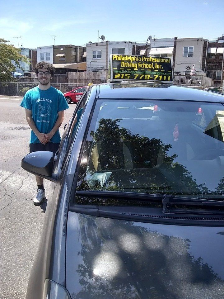 Young teen in blue shirt successfully passed driving school test