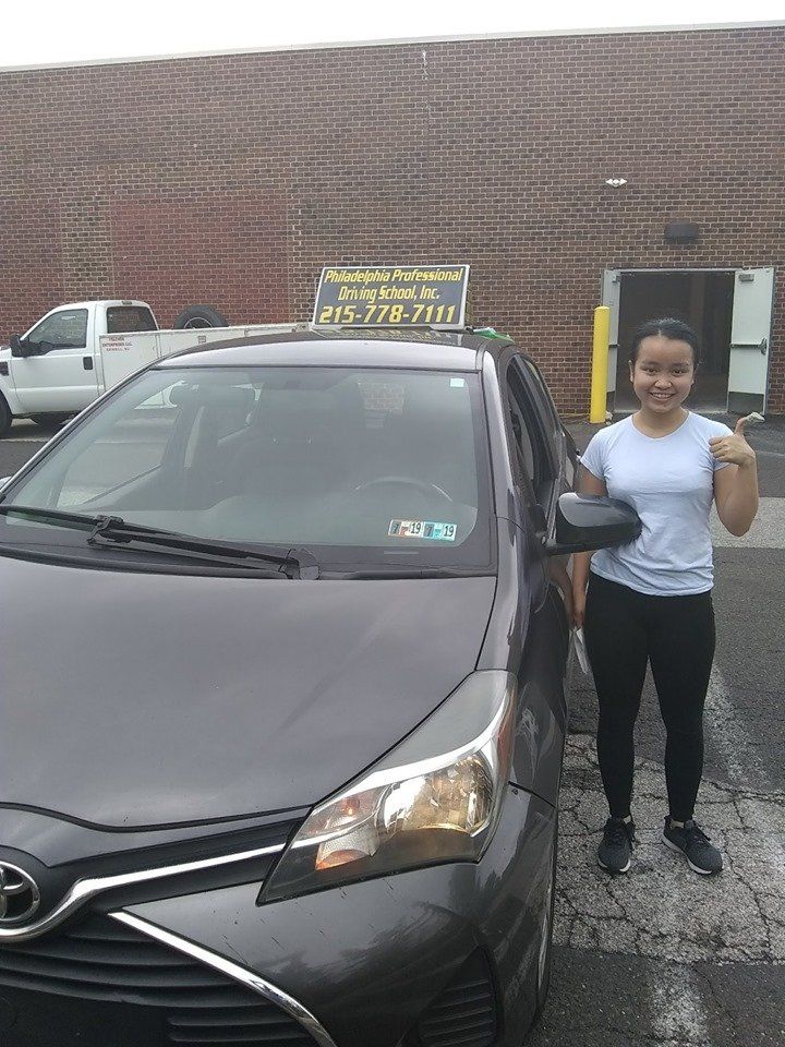 Teen girl doing ok sign after passing driving school test