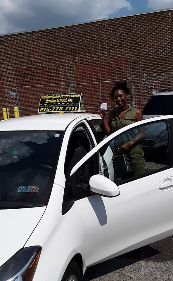 Woman in olive green shirt successfully passed driving school test