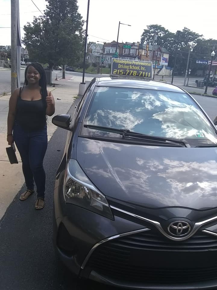 Happy woman in black shirt doing ok sign