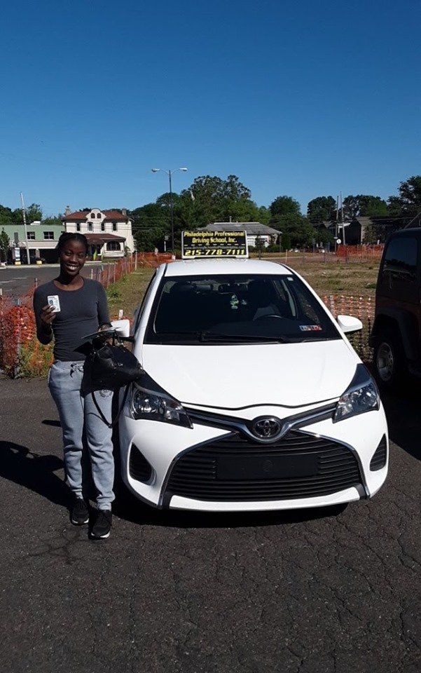 Female smiling and holding driver's license