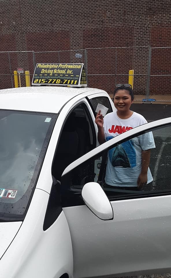 Teen holding paper after successfully passing driving school test