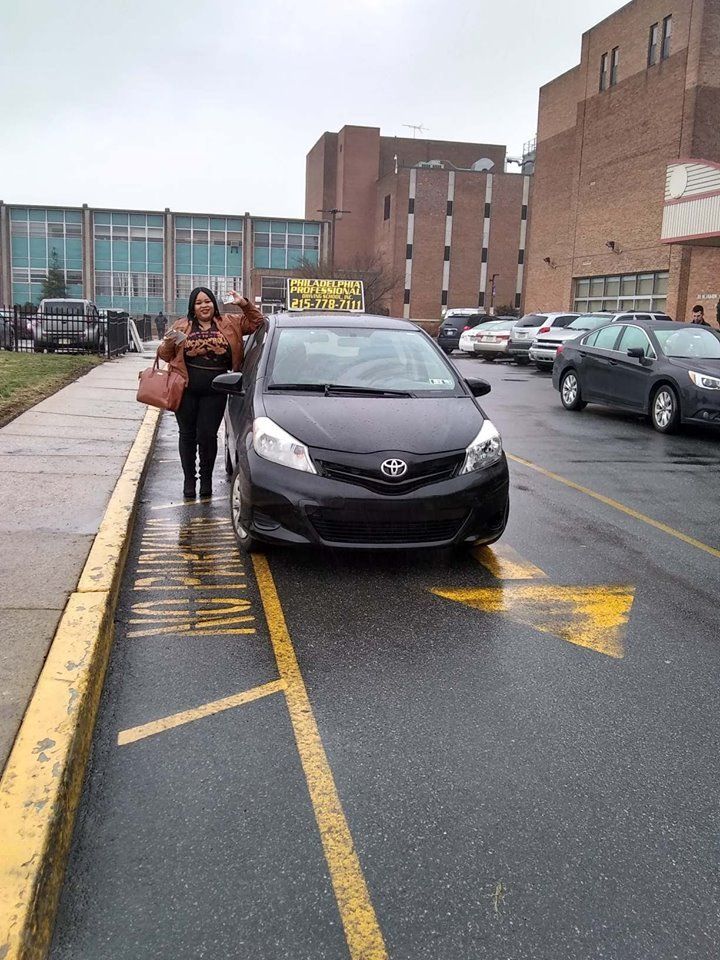 Happy woman holding driver's license