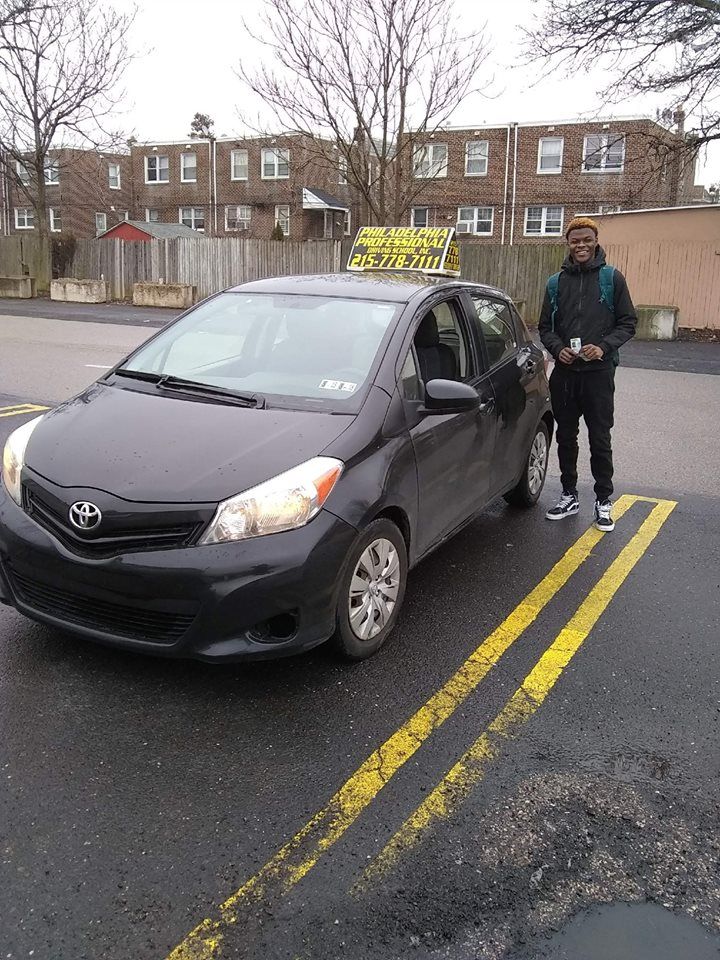 Happy teen holding driver's license