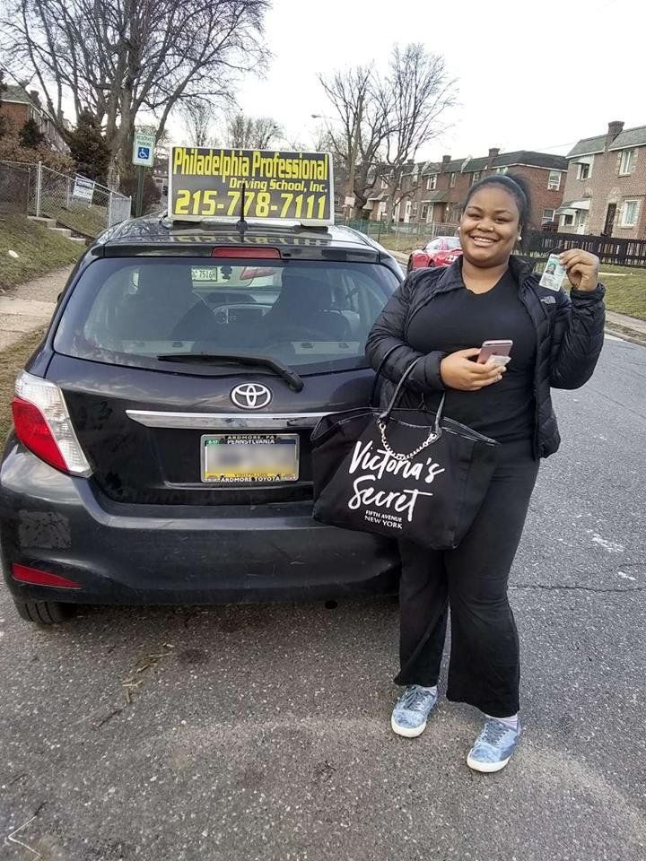 Smiling woman holding driver's license