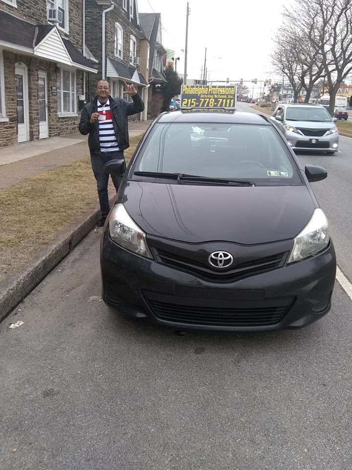 Man holding driver's after passing driving school test