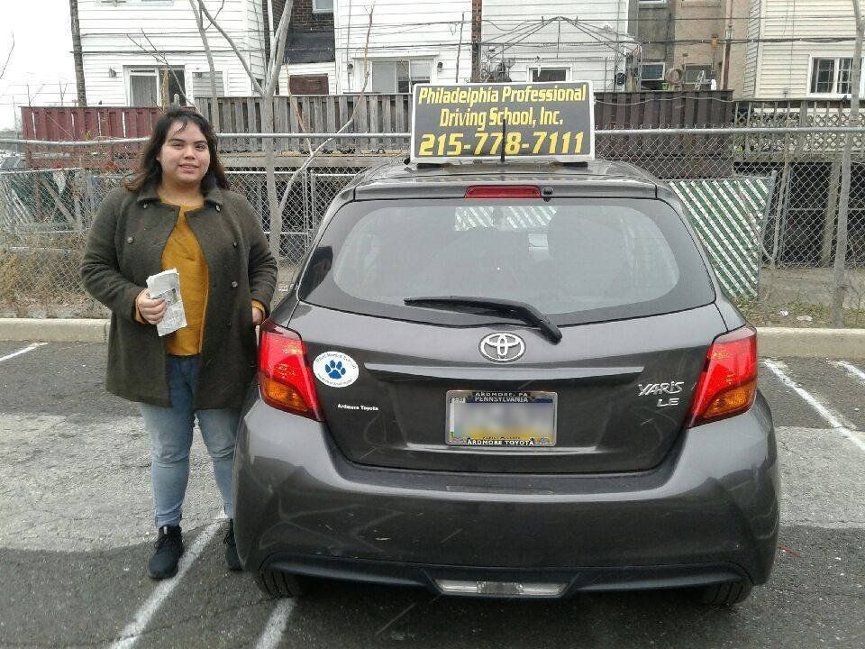 Smiling woman successfully passed driving school test