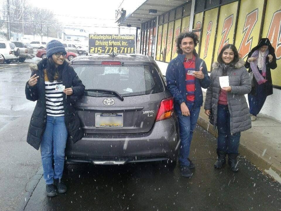 Group of friends holding driver's license
