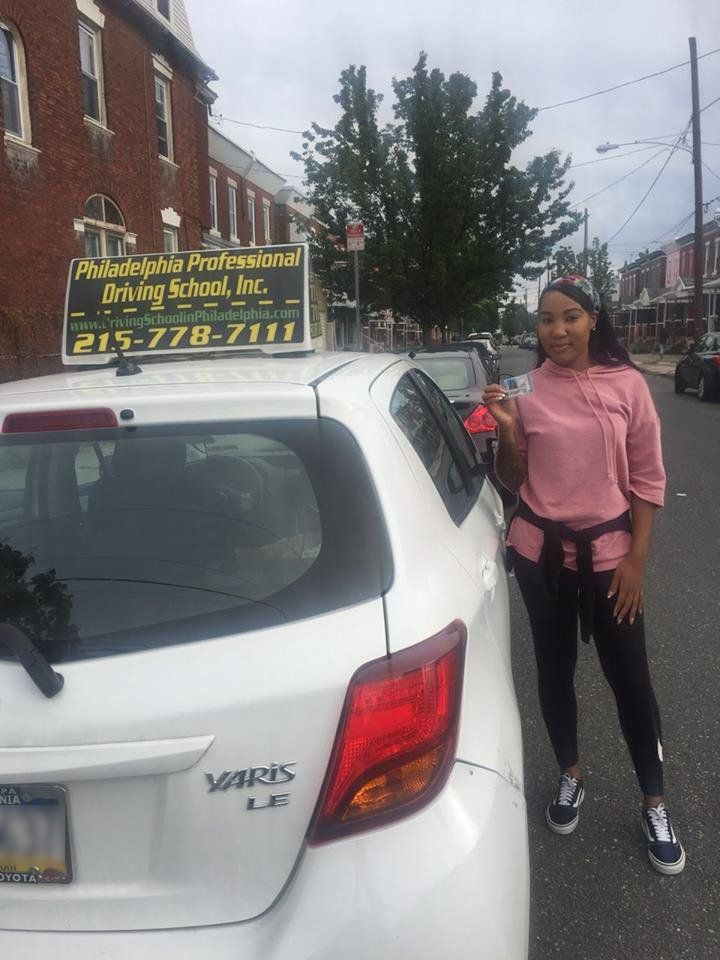 Teen holding driver's license after passing driving school test