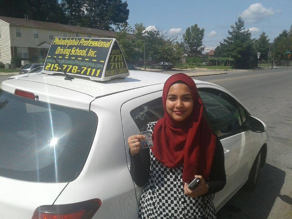 Happy woman holding driver's license after passing driving school test