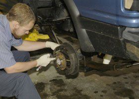 Mechanic repairing auto brake