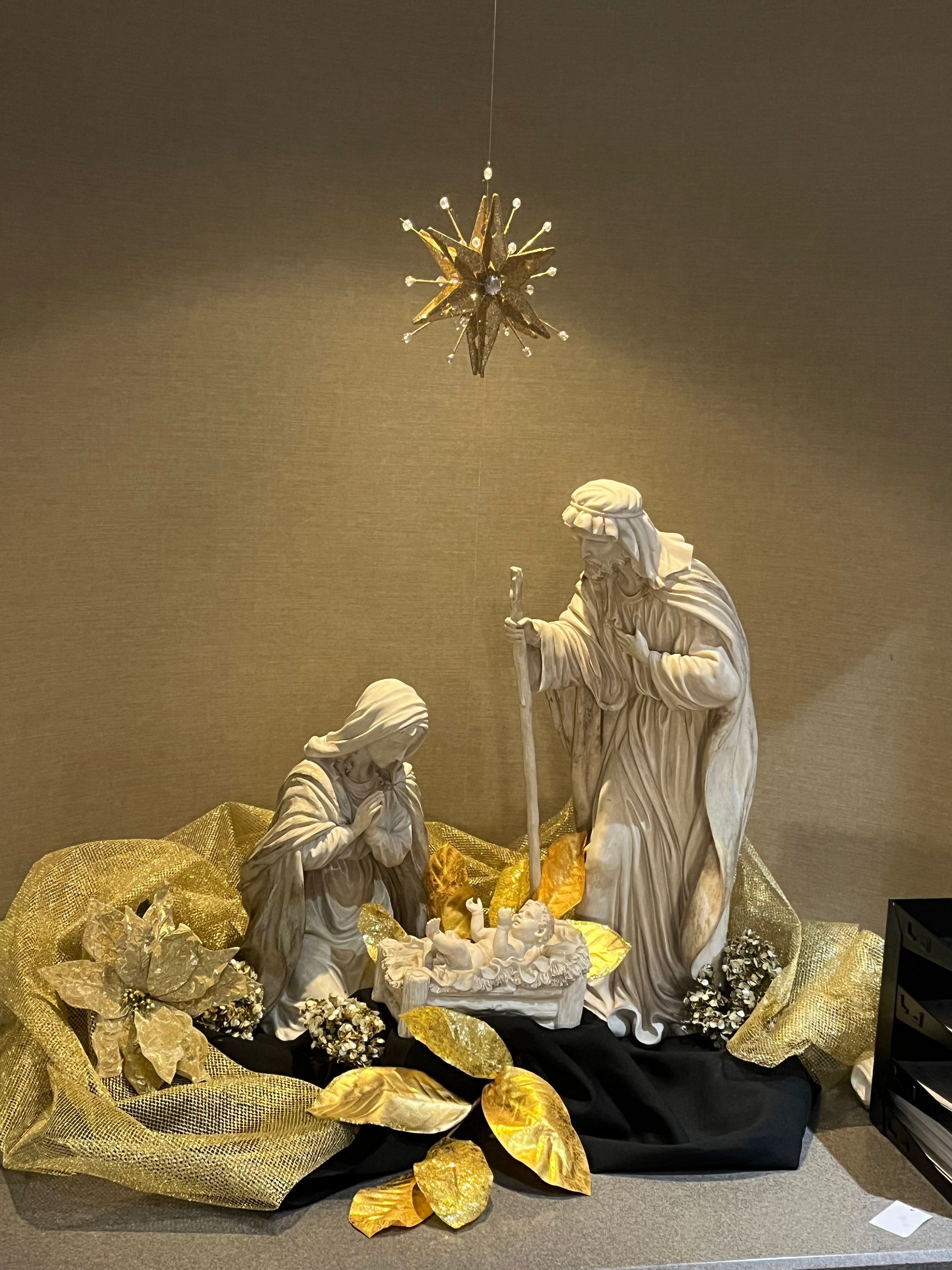 A nativity scene with a star hanging from the ceiling