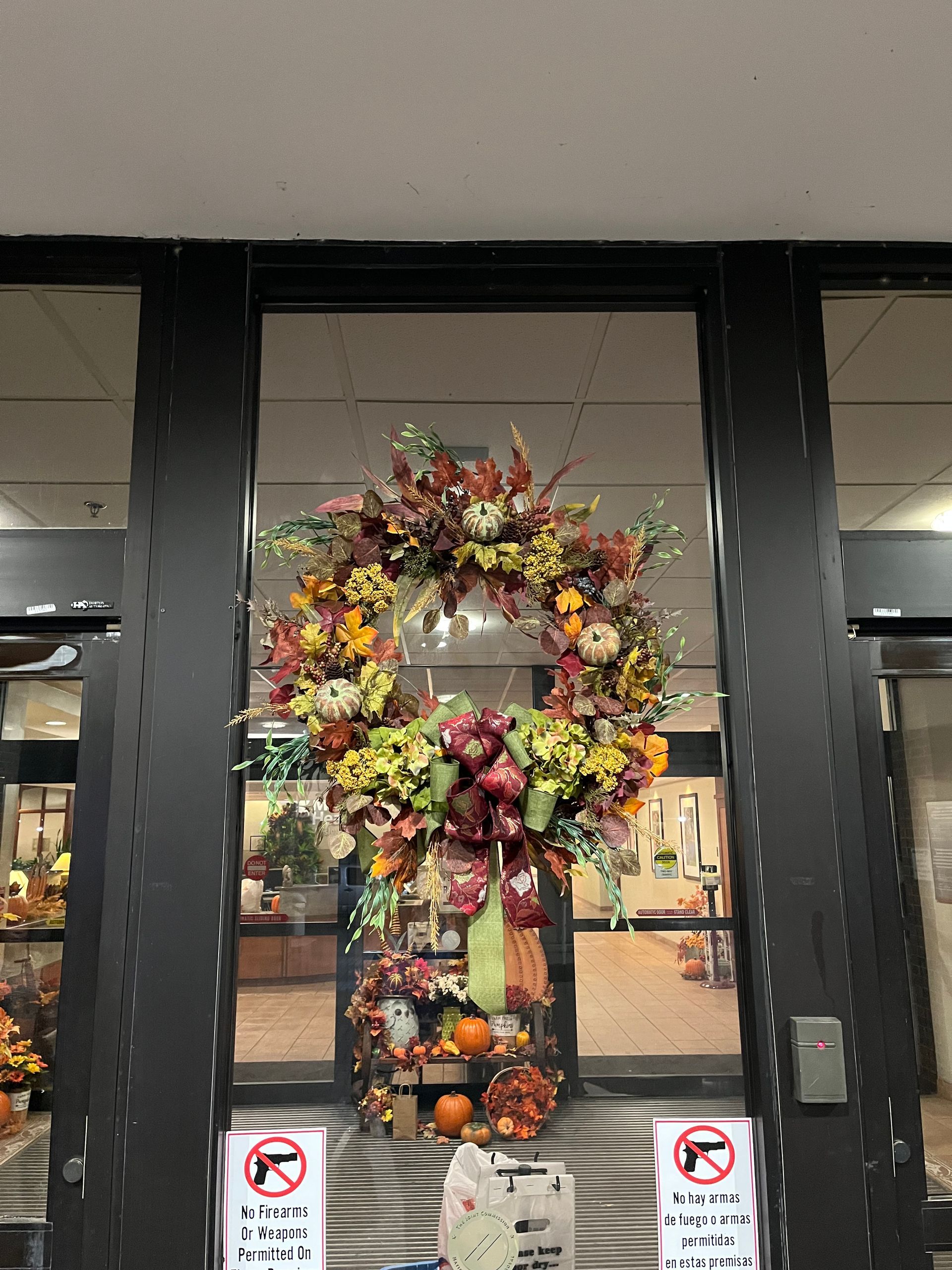 A wreath is hanging on the door of a building.