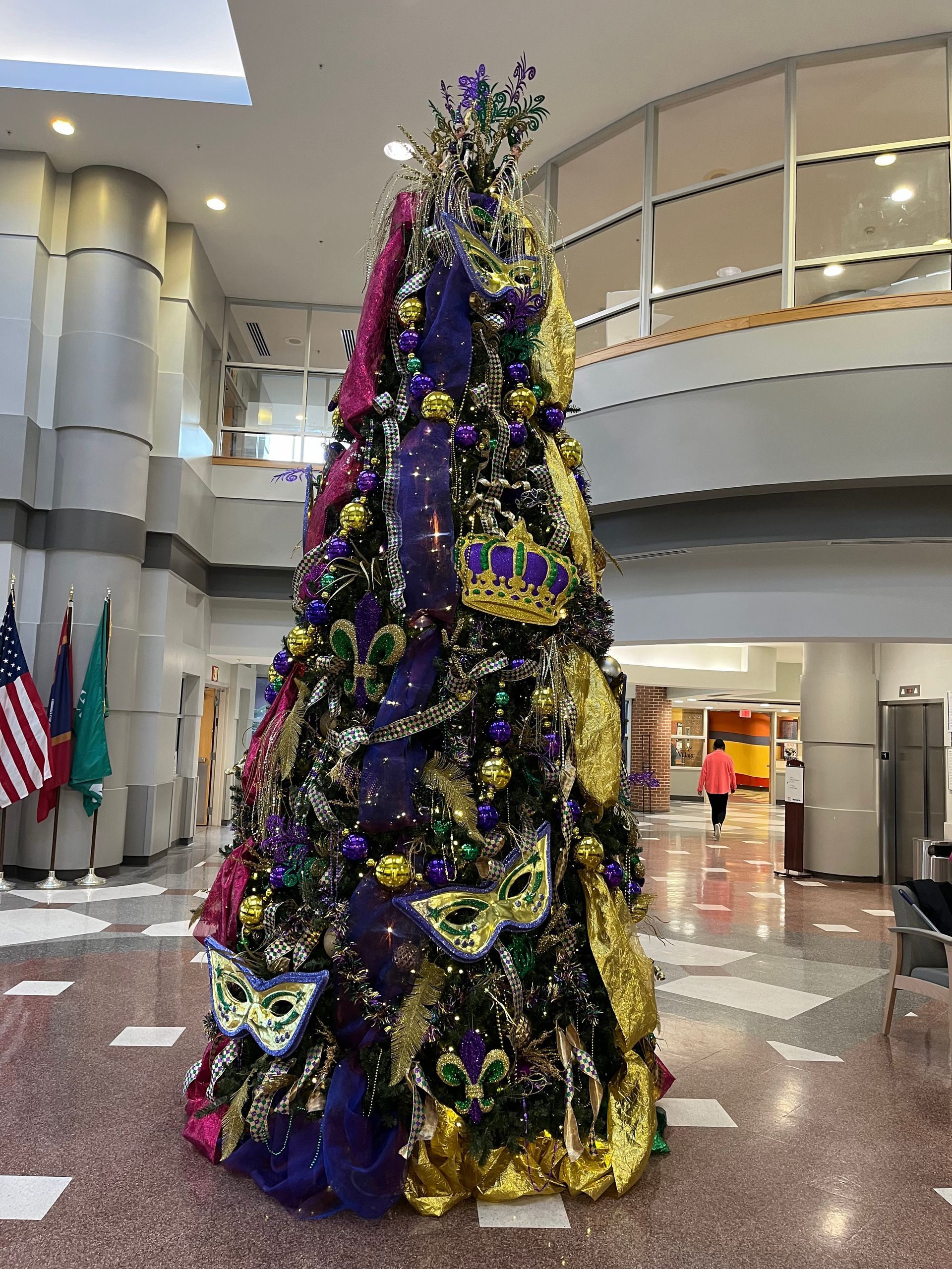 A large christmas tree with purple and gold decorations