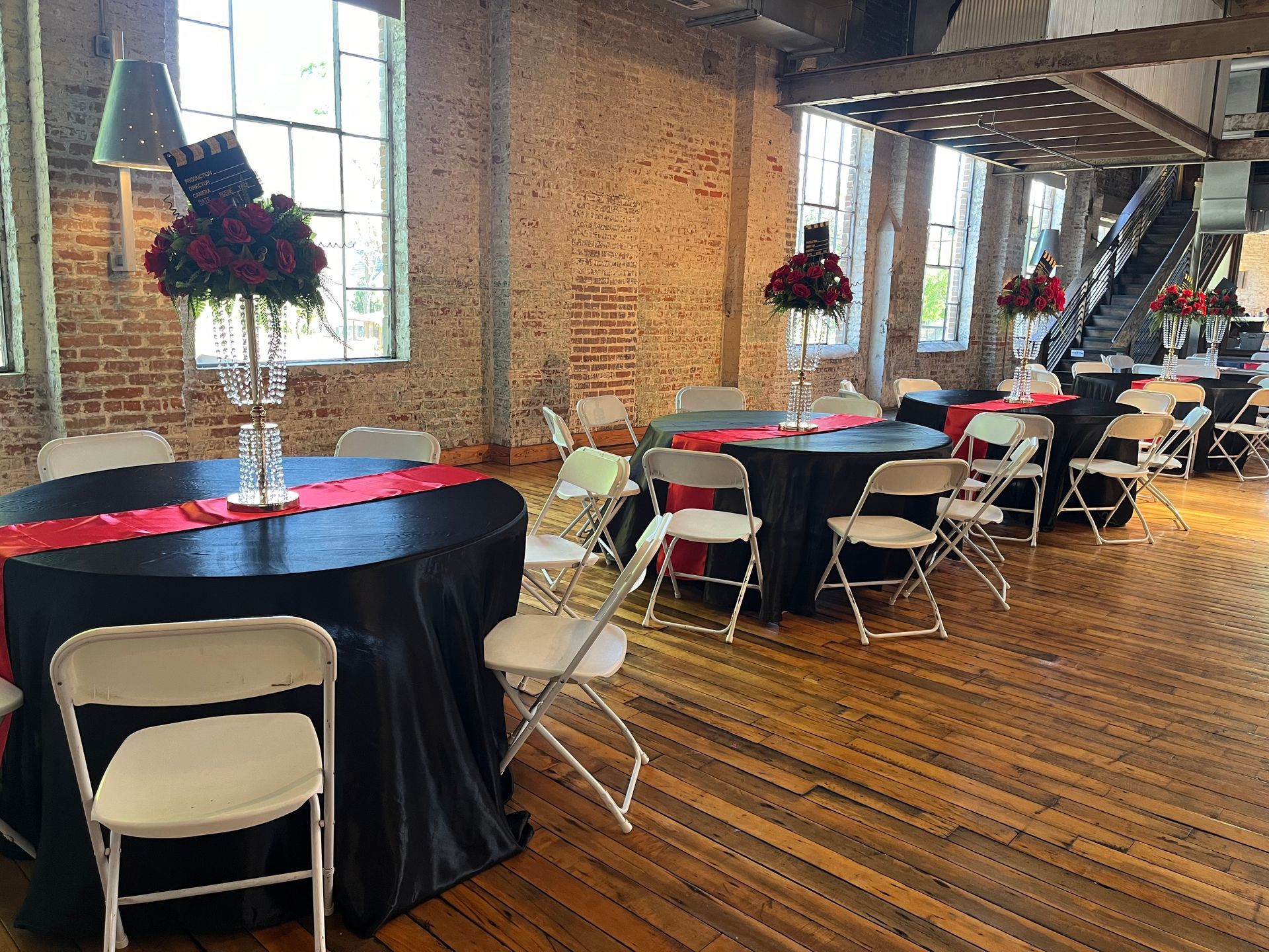 A large room with tables and chairs set up for a party.