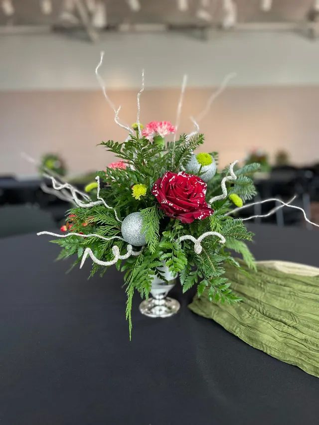 A vase filled with flowers is sitting on a table.