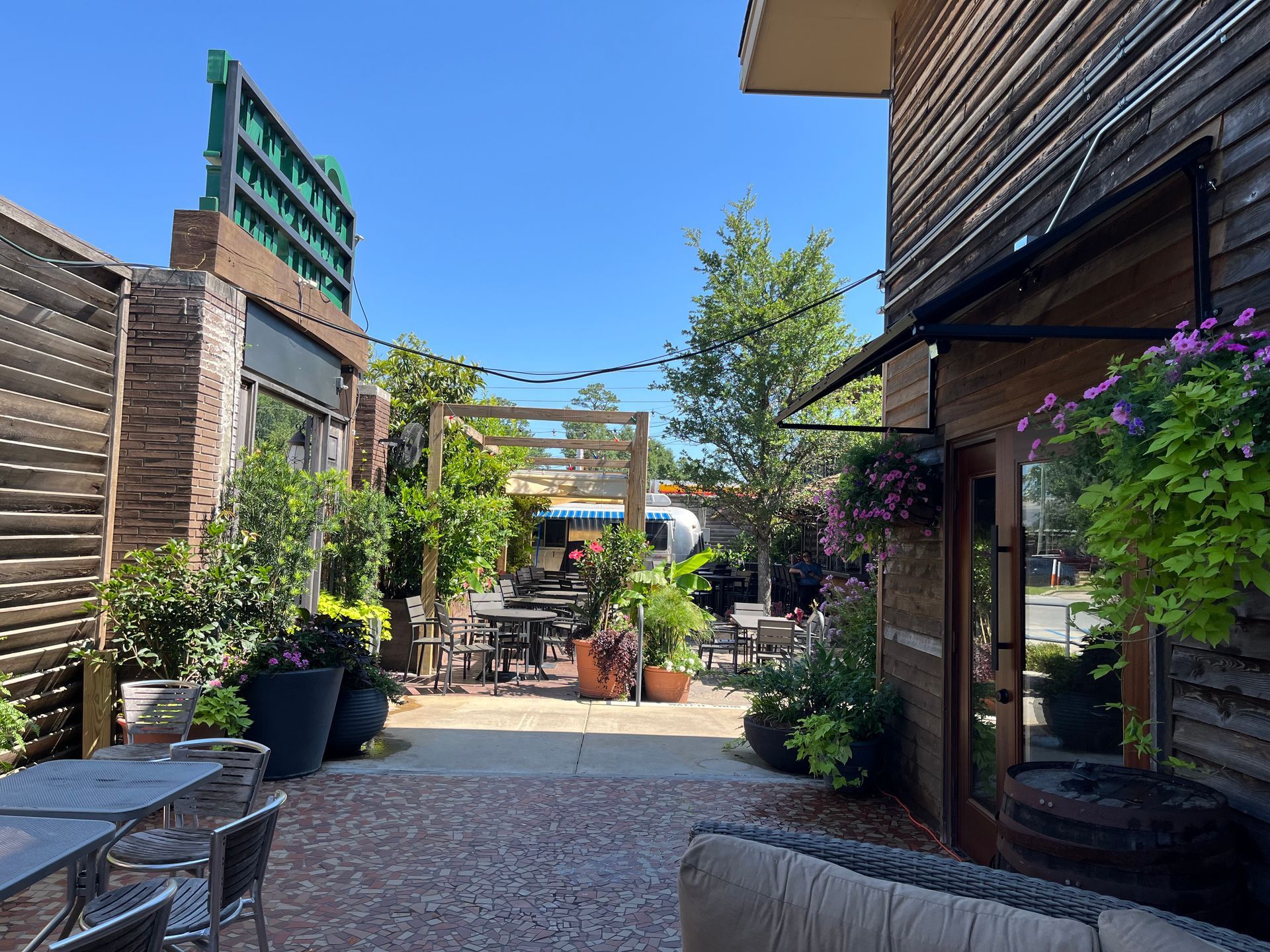 A patio with tables and chairs in front of a building.