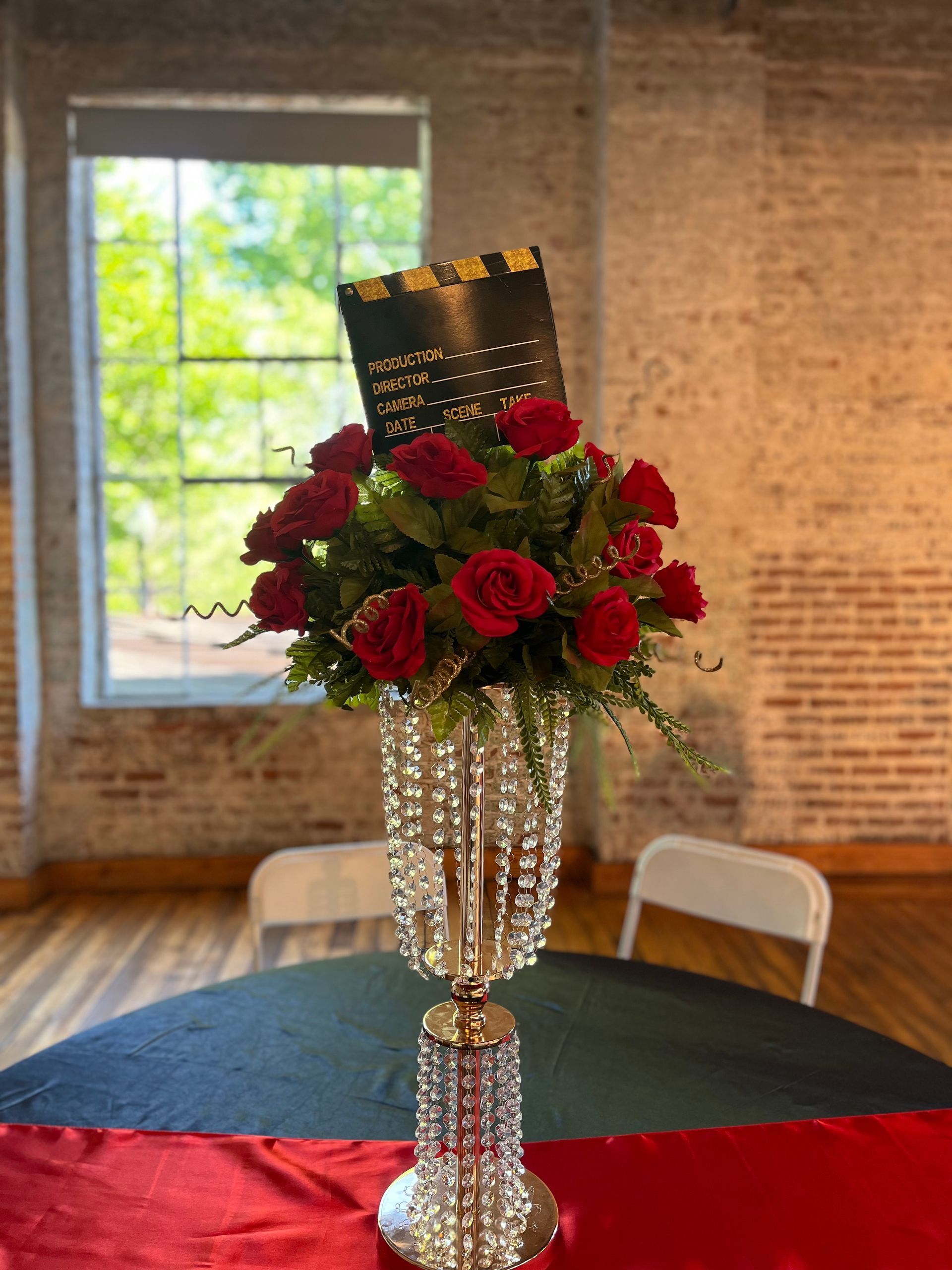 A vase filled with red roses is sitting on a table.