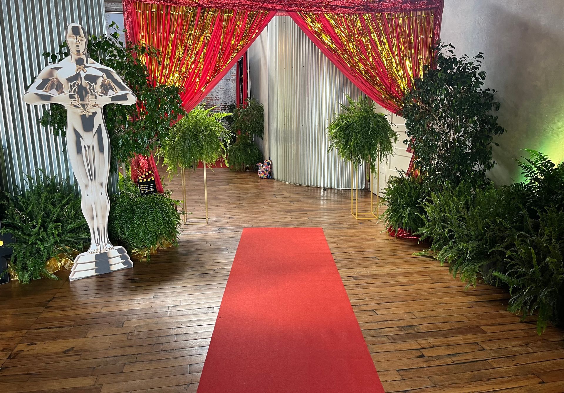 A red carpet is leading to a statue of an oscar winner.