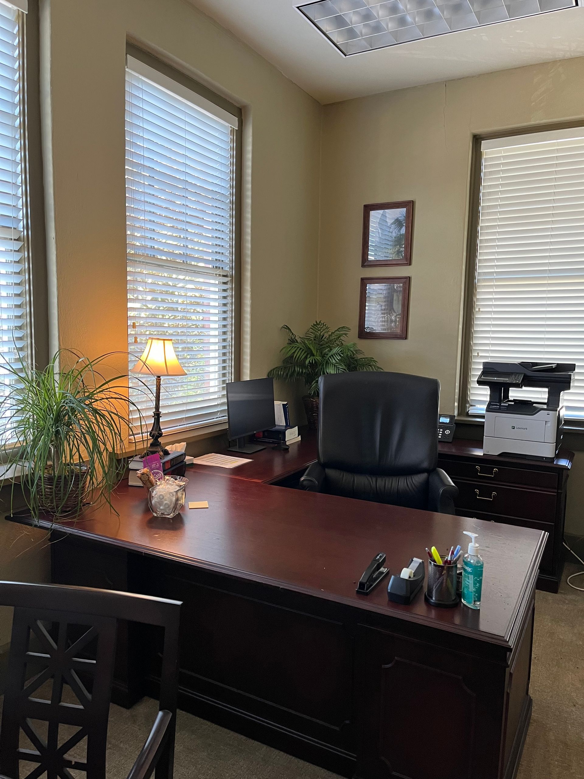 There is a desk and chair in the office.